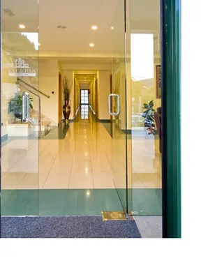 a lobby with a glass door and a hallway at Hotel Restaurante La Casilla in Cangas del Narcea
