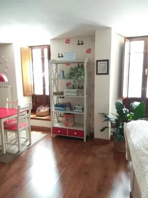 a room with a table and a book shelf at Apartamento Cine Colón in Ribadeo