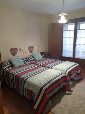 two beds sitting next to each other in a bedroom at Apartamento Cine Colón in Ribadeo