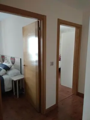a room with a door leading to a room with a couch at Apartamento Cine Colón in Ribadeo