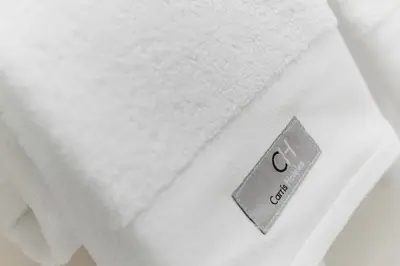 a close up of a white towel on a bed at Carris Cardenal Quevedo in Ourense