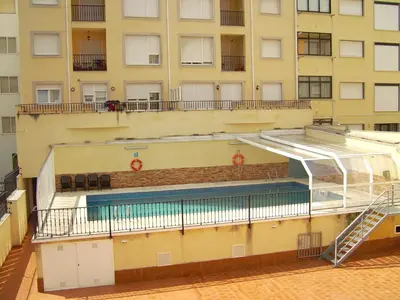 an external view of a building with a swimming pool at Tres dormitorios con magníficas vistas al mar in Foz