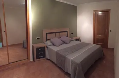 a bedroom with a bed and a large mirror at Tres dormitorios con magníficas vistas al mar in Foz