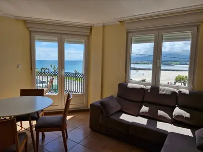 a living room with a couch and a table at Apartamento Foz Playa in Foz