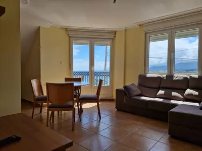 a living room with a couch and a table at Apartamento Foz Playa in Foz
