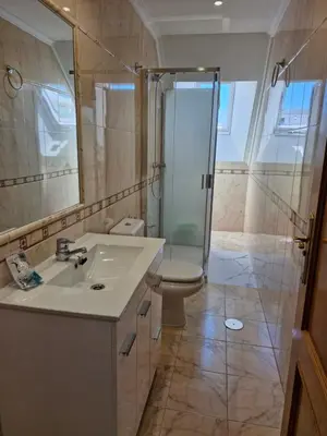 a bathroom with a toilet and a sink and a shower at Apartamento Foz Playa in Foz