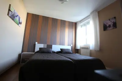 a bedroom with a bed and a window at PR Plaza de Galicia in Santiago de Compostela