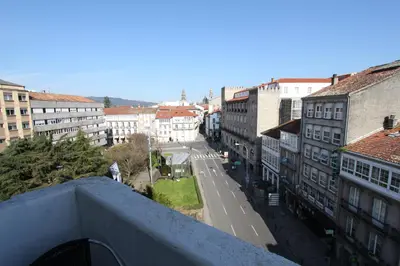a view of a city street from a balcony at PR Plaza de Galicia in Santiago de Compostela