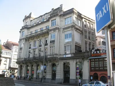 a large white building on the corner of a street at PR Plaza de Galicia in Santiago de Compostela