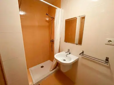 a bathroom with a sink and a toilet and a mirror at Alojamientos Barreiros 3000 in Barreiros