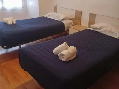 a hotel room with two beds with towels on them at Alojamientos Foz 3000 in Foz