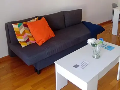 a living room with a couch and a white coffee table at Alojamientos Foz 3000 in Foz