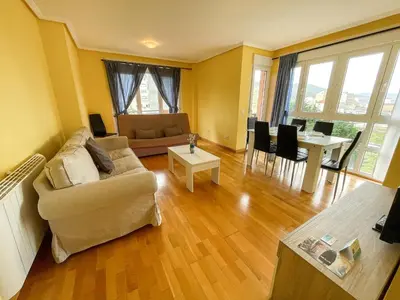 a living room with a couch and a table at Alojamientos Foz 3000 in Foz