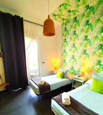 a hotel room with two beds and a window at Hostal Mafer in Santiago de Compostela