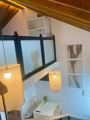 a room with two pendant lights and a table at Casa de Campo Cruz de Pedra in Portomarin