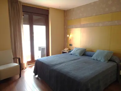 a bedroom with a large bed and a large window at Isla Nova Hotel in Foz