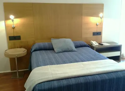 a hotel room with a bed and a telephone at Isla Nova Hotel in Foz
