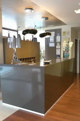 a lobby with a reception desk in a building at Isla Nova Hotel in Foz
