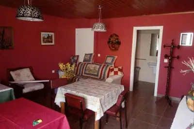a dining room with a table and red walls at Hospedaje Mendez in Lugo