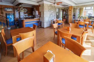 a restaurant with wooden tables and chairs at As Areas I in Viveiro