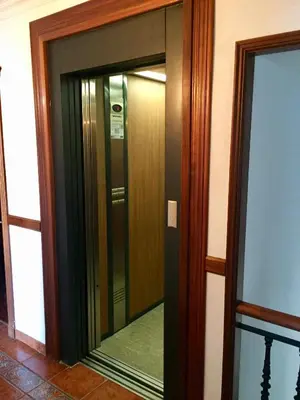 a glass elevator in a building with a mirror at As Areas I in Viveiro