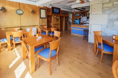 a dining room with wooden tables and chairs at As Areas I in Viveiro