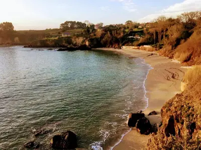 a view of a beach with rocks and water at Villa Dorneda in Oleiros