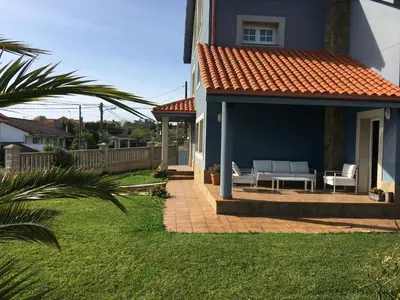 a house with a patio with a table and chairs at Villa Dorneda in Oleiros