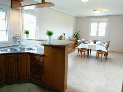 a kitchen with a table and a dining room at Villa Dorneda in Oleiros