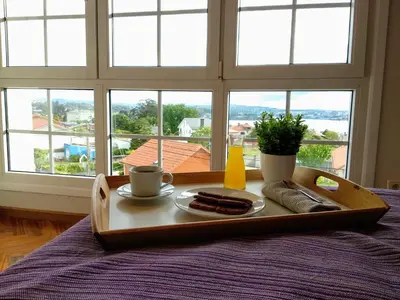 a tray of food on a table in front of a window at Villa Dorneda in Oleiros