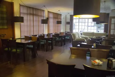 a dining room with tables and chairs and a cafeteria at As Areas II in Viveiro
