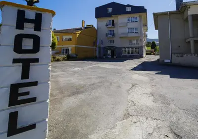 an empty parking lot in front of a building at As Areas II in Viveiro