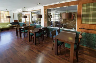 a dining room with wooden tables and chairs at As Areas II in Viveiro