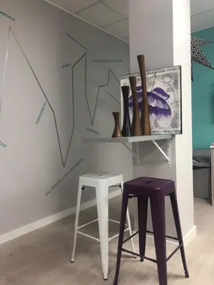 a room with two stools and a wall with graphs at Augas Quentes Hostel in Ourense
