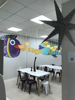 a dining room with tables and a star hanging from the ceiling at Augas Quentes Hostel in Ourense