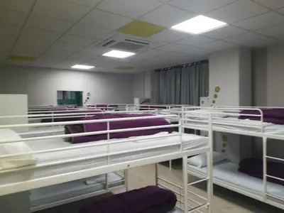 a row of bunk beds in a room at Augas Quentes Hostel in Ourense