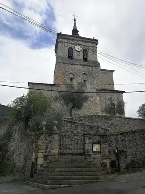 an old building with a clock tower on top of it at Casa Blanquita in Molinaseca