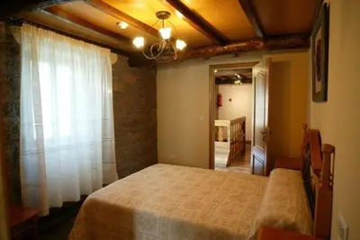 a bedroom with a large bed in a room at Costa da Egoa in Carral