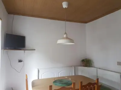 a dining room with a table and a pendant light at Casa de Labranza Naz in Sober