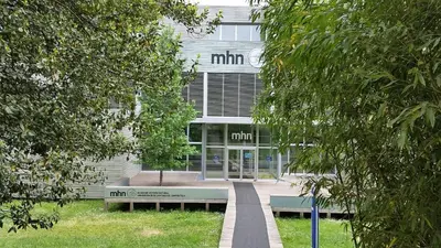 a building with a bench in front of it at AdA Apartamento in Santiago de Compostela
