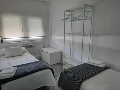 a bedroom with two beds and a glass shelf at AdA Apartamento in Santiago de Compostela