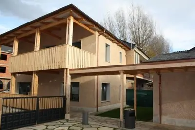 a house with a balcony on top of it at Alojamiento Ubaldo Nieto in Carracedo del Monasterio