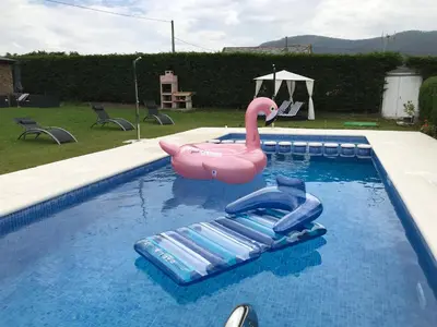 a pink plastic swan in a swimming pool at Villas Las Catedrales in Ribadeo