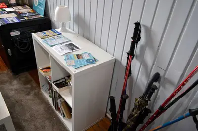 a small white shelf with two baseball bats on it at Albergue O Fogar de Teodomiro in Santiago de Compostela
