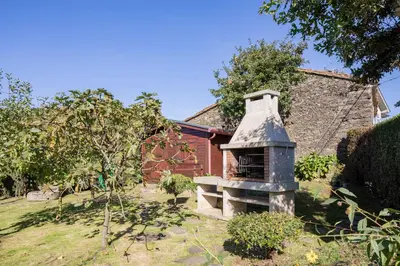 a brick oven in the yard of a house at Casa Rural Dona María in Ordes