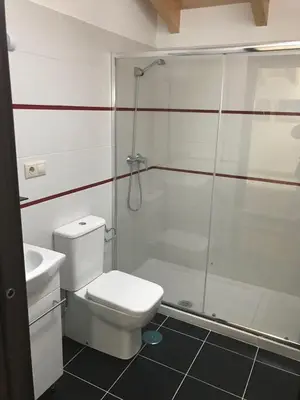 a bathroom with a shower and a toilet and a sink at kilometro 15 in Amenal
