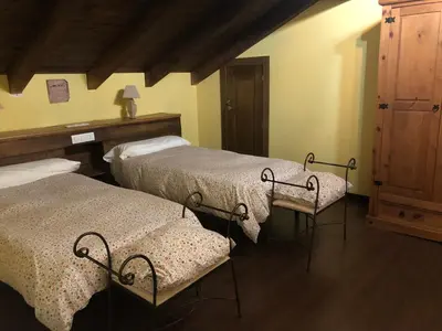 a bedroom with two beds and a dresser in it at Casa Corral - Casas de Aldea in Monón