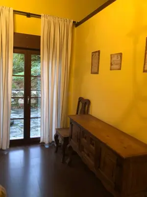 a room with a wooden table and a sliding glass door at Casa Corral - Casas de Aldea in Monón