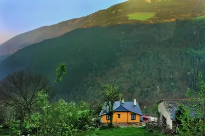 a house on the side of a hill with a mountain at Casa Corral - Casas de Aldea in Monón