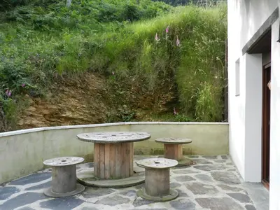 a table and two stools on a patio at Casa Corral - Casas de Aldea in Monón